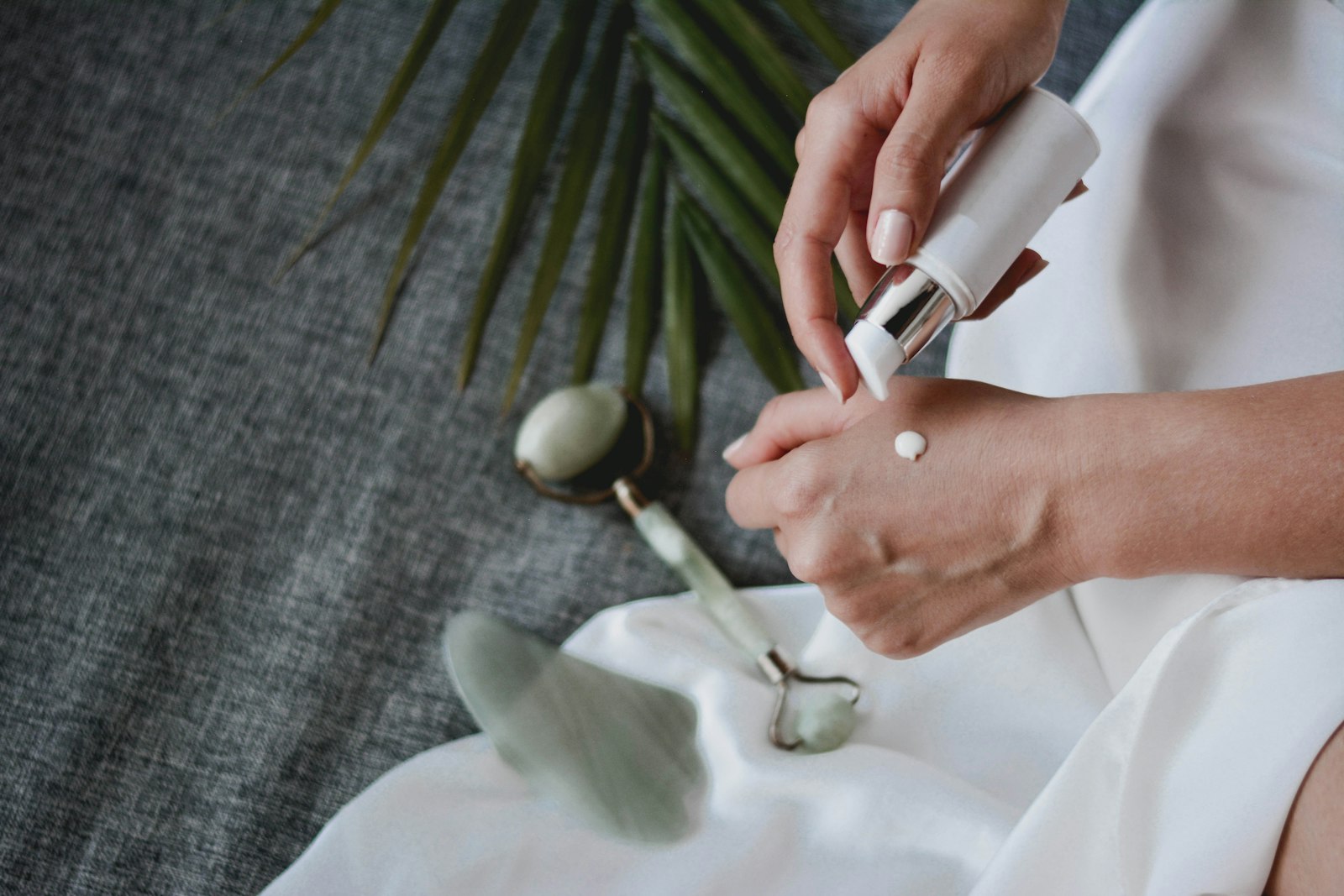 Hands smoothing a cream into the skin